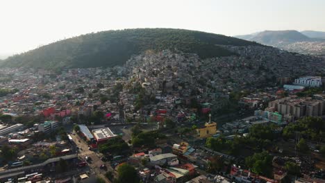 North-of-Mexico-city-hill,-aerial-drone-establishing-shot,-traveling-left-tilt-down