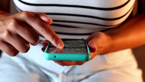 overhead view of woman’s hands scrolling smartphone