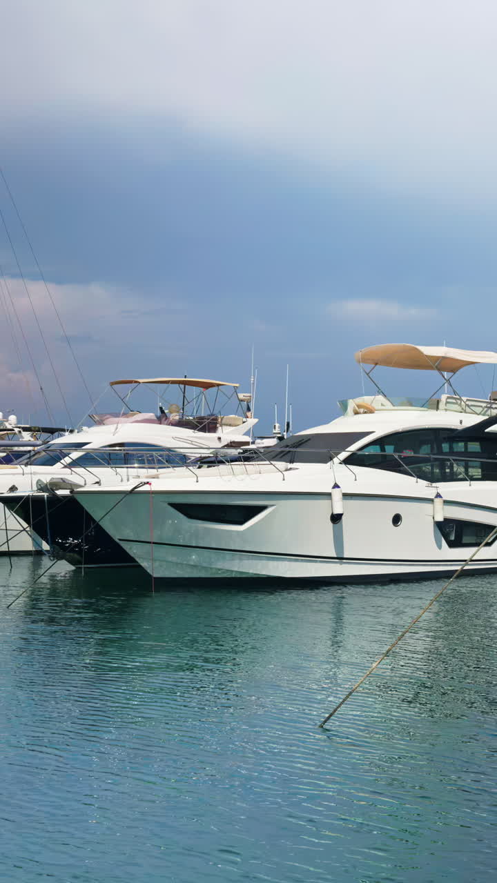 White boats docked in the Port Vauban in Antibes, France. Vertical