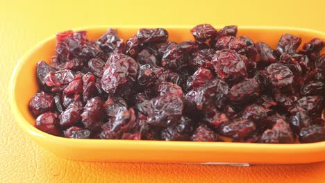 dried cranberries in an orange bowl