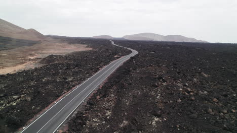 Aerial-Casacoral-Road-with-little-Tornado,-near-Pueblo-Tenesar-in-Lanzarote,-Canary-Islands