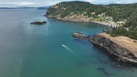 Establishing-aerial-view-of-Rosario-Beach-with-a-motorboat-ripping-through-the-water-underneath