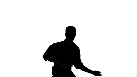 silhouette of man jumping and gesturing on white background