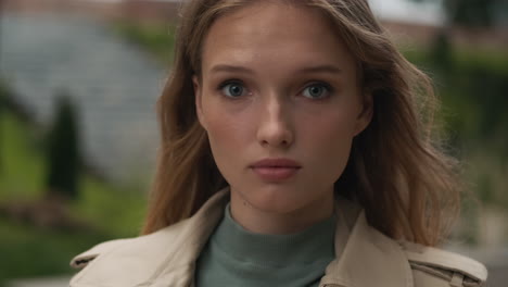 caucasian woman looking at the camera outdoors.