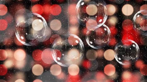 animation of snow falling over christmas baubles