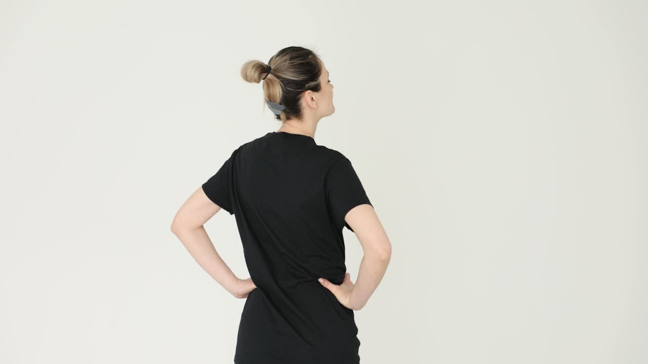 Woman in black t-shirt with bun hairstyle