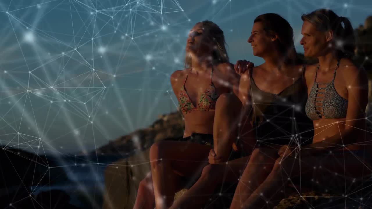 animación de una red de conexiones sobre amigas abrazándose en la playa
