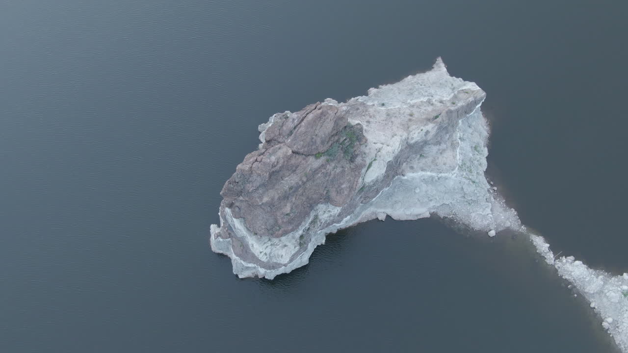 La Sorrueda dam, Gran Canaria: aerial view over one of the dam's rock formations with the water completely calm and on a sunny day