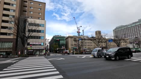 vehicles and pedestrians crossing city intersection