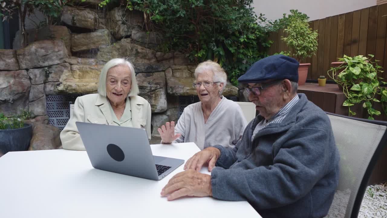 Seniors making video call in a garden