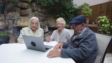 seniors making video call in a garden