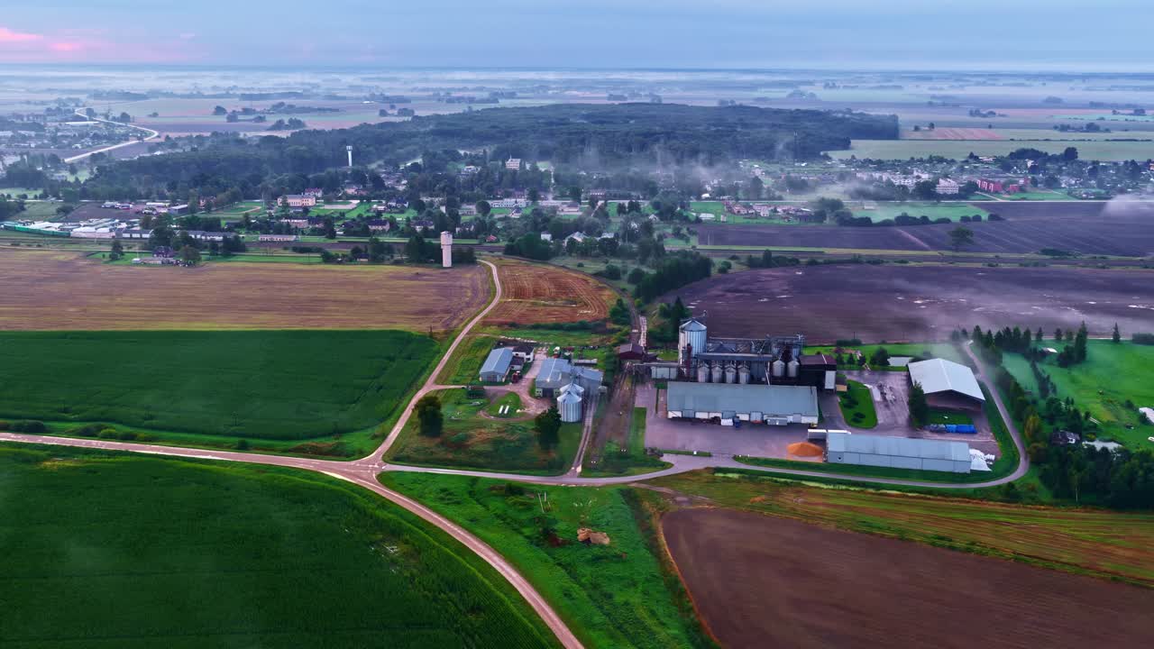 Aerial shot capturing an industry located at rural countryside beside an isolated town
