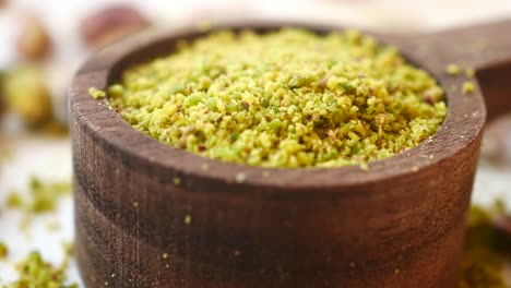 ground pistachios in wooden bowl