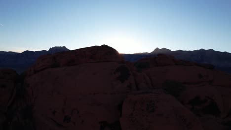 aerial-footage-of-red-rock-formation-canyon-In-Las-Vegas-California,-drone-revealing-scenic-morning-sunrise