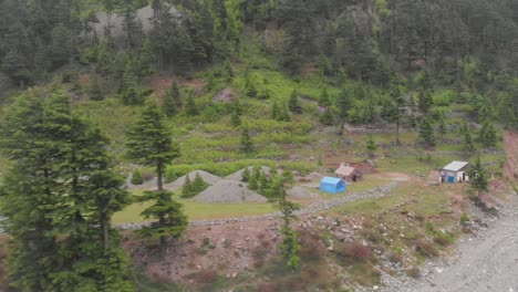 aerial of camp site beside mountainside beside riverbank at kalam valley in pakistan