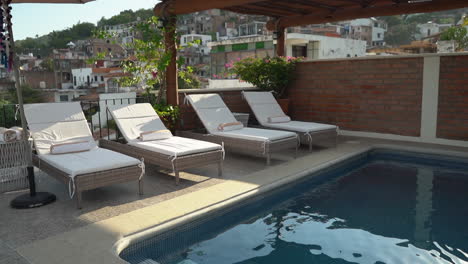 luxury rooftop pool on a villa with a scenic view and lounge chairs - push in view