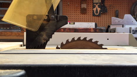 table saw blade being raised up from inside table