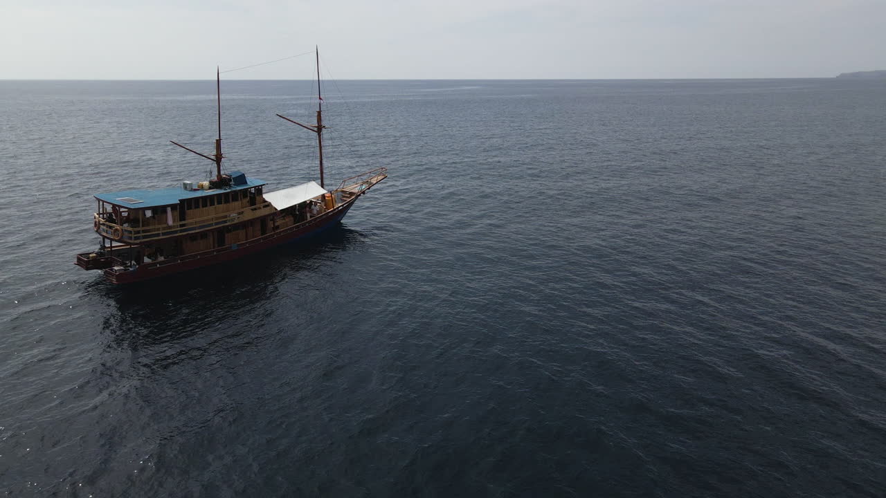 Traditional Wooden Boat Cruise Sailing In The Ocean With Calm Water.  - aerial