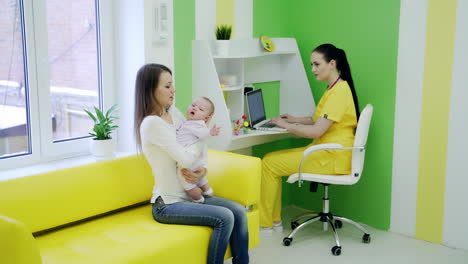 mother with girl being examined by female pediatrician