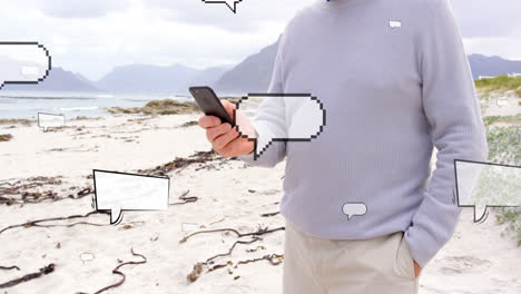animación de burbujas de habla sobre la sección media de un hombre caucásico que usa un teléfono inteligente en la playa