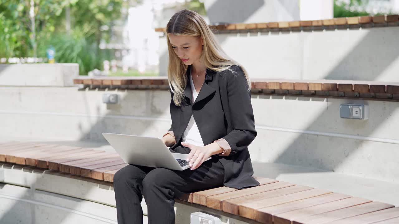 Businesswoman Working on Laptop Outdoors