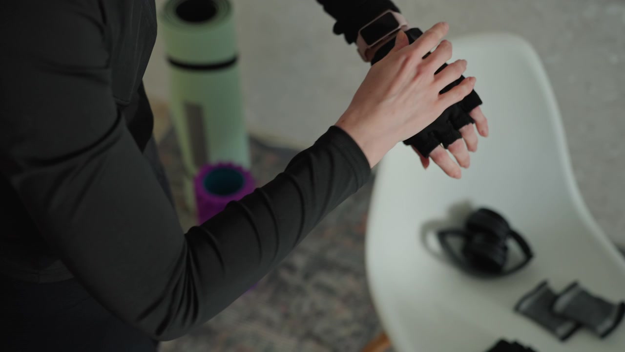 Female individual organizes equipment for training session. Quiet scene showing woman setting up for fitness routine. Serene depiction of woman preparing her exercise gear for workout session
