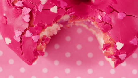pink heart donut with a bite taken out