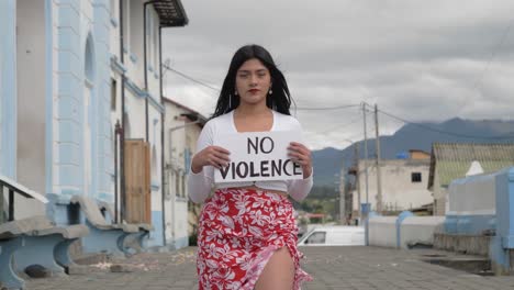 portrait clip of a young brunette latin girl holding the message "no violence