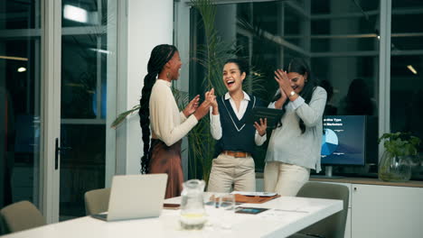 successful businesswomen celebrating in modern office