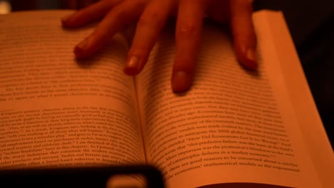 reading a book, hand over pages