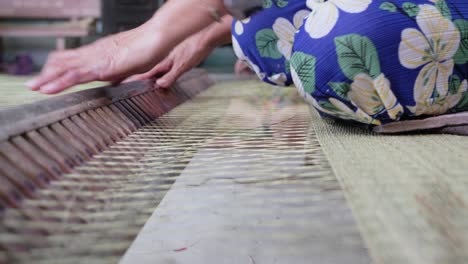 close up of the process of sedge mat weaving popular in asian tradition