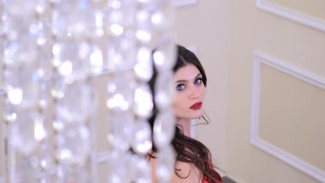 woman in red dress with crystal chandelier