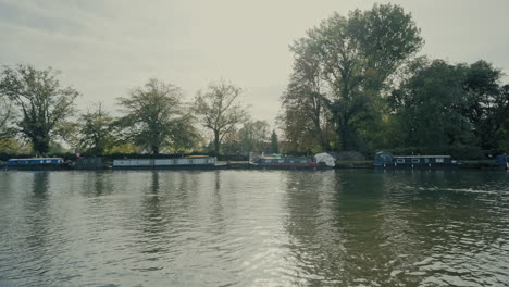 canal boats docked along the river thames in oxford