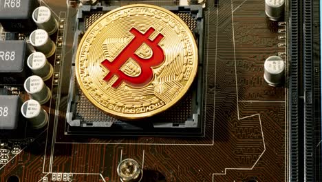 Gold Bit Coin BTC coins on the motherboard. Bitcoin is a worldwide cryptocurrency and digital payment system called the first decentralized digital currency.