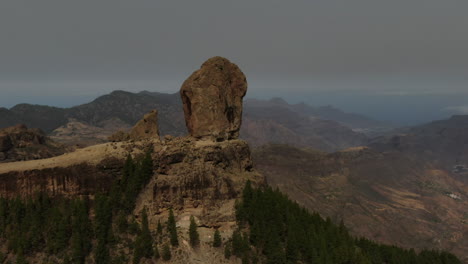 Roque-Nublo,-Gran-Canaria:-Wonderful-aerial-shot-at-close-range-and-during-sunset-of-Roque-Nublo-on-the-island-of-Gran-Canaria