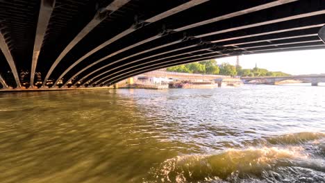 dinner cruise passing under a bridge on the seine river, paris