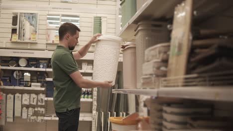 man shopping for storage baskets in a home goods store