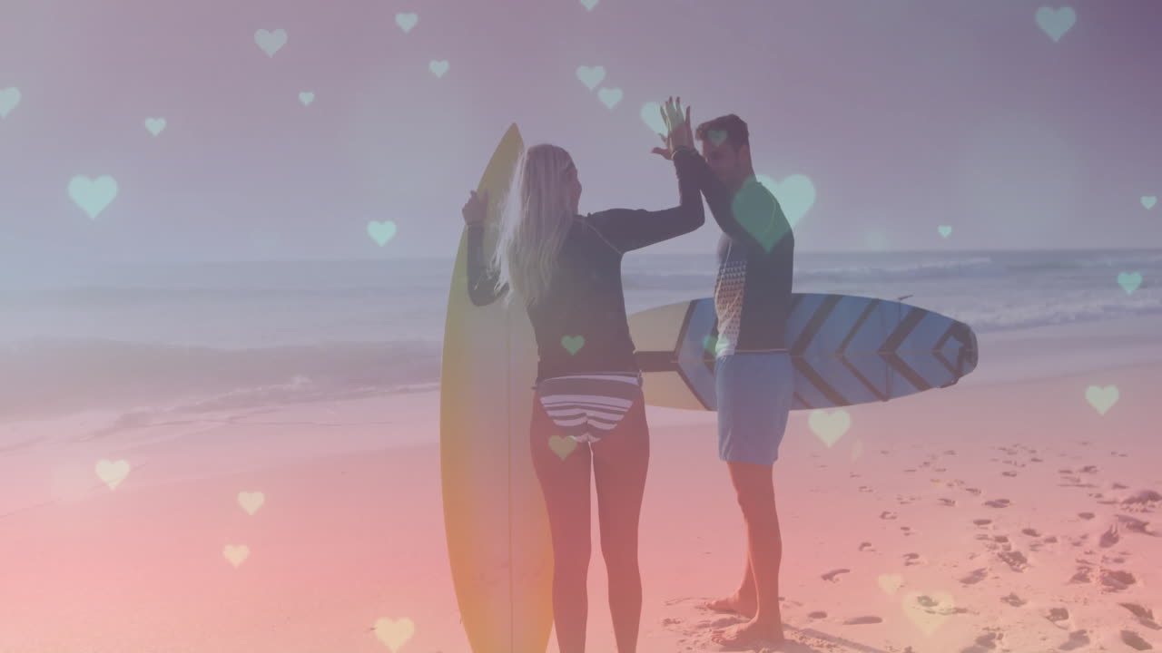 woman surfer holding yellow board beside man holding blue board under heart lights for travel ads