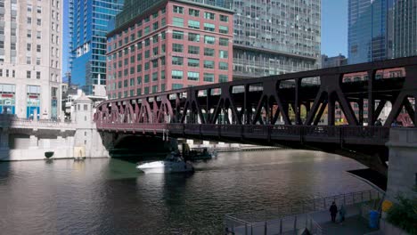 chicago river in chicago, illinois with boat under bridge and stable video