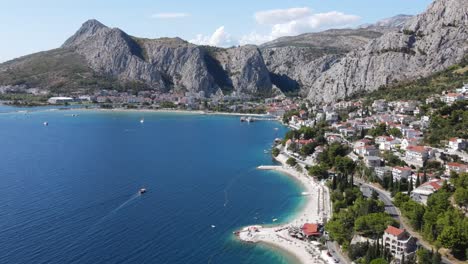 Following-the-coastal-road-in-Croatia,-an-aerial-view-over-white-beaches-and-deep-blue-sea
