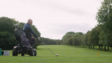 a golfer playing golf from a golf cart