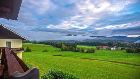 view from the balcony of a rural house in the middle of a green landscape