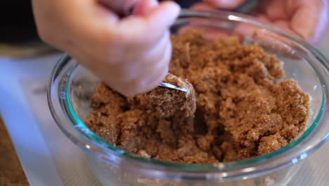 mixing brown sugar, cinnamon and butter with a fork for cinnamon roll filling - slow motion