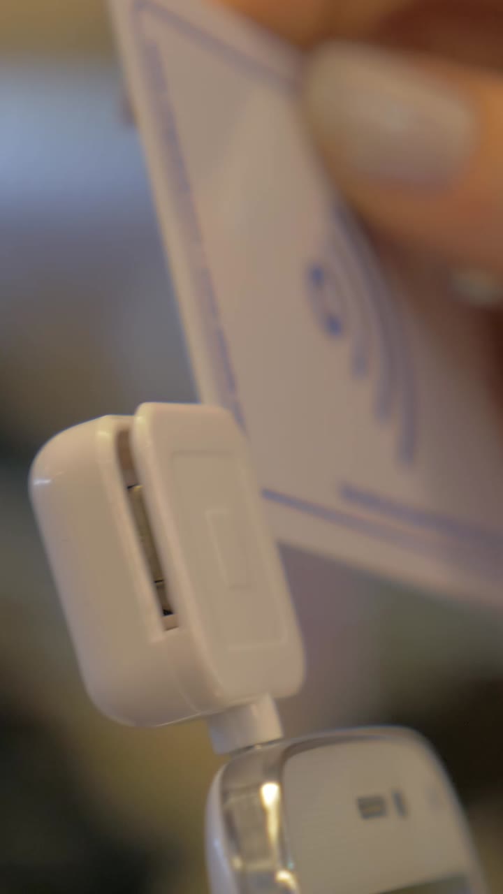 Hand Inserting Credit Card into Mobile Payment Terminal