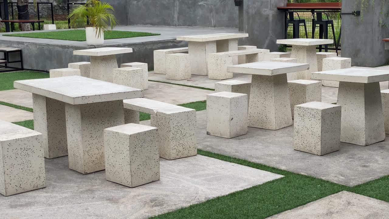 The footage shows the coffee shop's outdoor concept customer tables and chairs, using modern aesthetic stone and wood.
