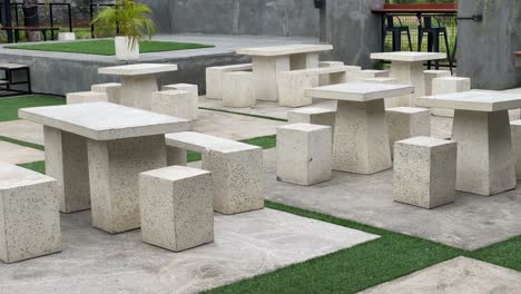 the footage shows the coffee shop's outdoor concept customer tables and chairs, using modern aesthetic stone and wood.
