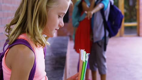 Schoolkid-bullying-a-sad-girl-in-corridor-at-school