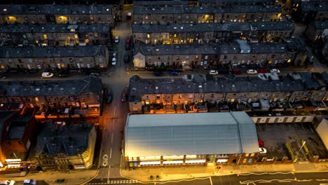 this hyperlapse is very fast moving and showcases halifax road in todmorden at night , sweeping along finishing with a shot of old terraced housing