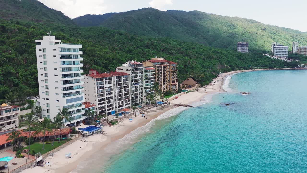 Aerial view of hotels along the beach in puerto vallarta, mexico, showcasing the vibrant coastline where the rainforest meets the sea