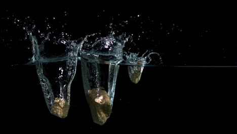 gold nuggets falling into water